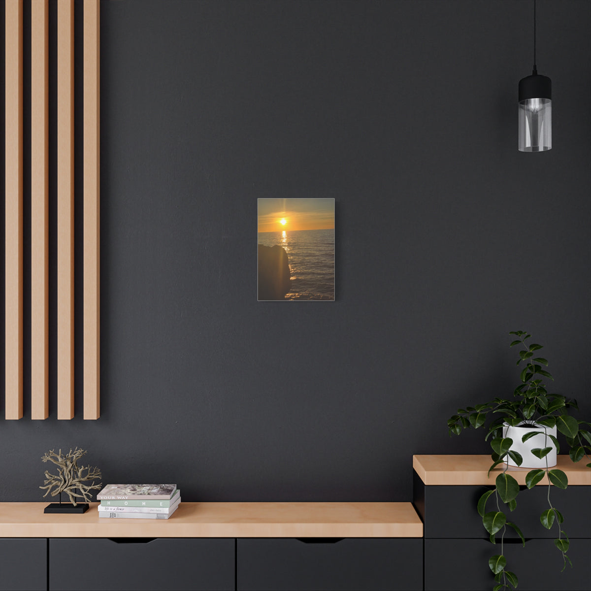 Break Wall Ocean View canvas print — golden sunset ocean canvas in a dark modern room with wood shelving and plants